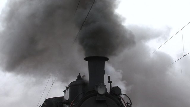 A smoking chimney steam locomotive