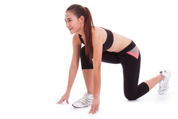 Sport woman in position to start running on white background