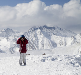 Fototapeta na wymiar Little skier on top of ski slope at sun day