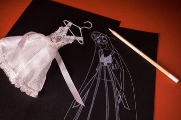 studio grafico per nuovo abito da sposa con modello in miniatura