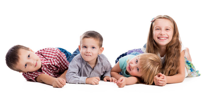 four cute children lying on the floor