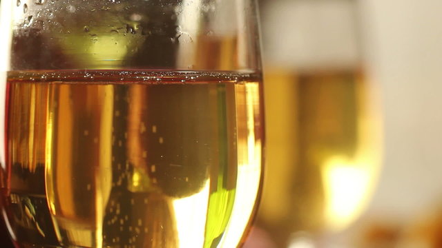 Close up of a pair of champagne flutes with bubbles.