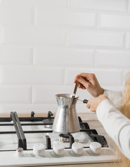 Close-up of brewing coffee in the turk. shallow DOF
