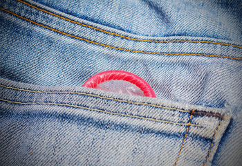 Condoms peeking out from jeans pocket.