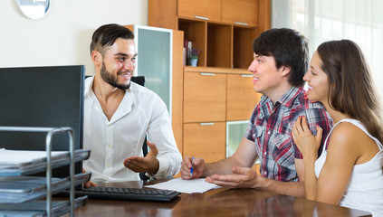 Couple drawing up an agreement at office.