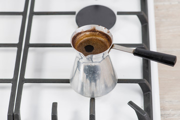 Turk for coffee on a gas cooker. shallow DOF