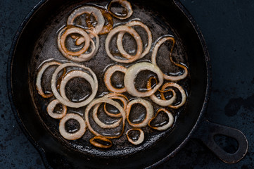 Onion rings in frying pan