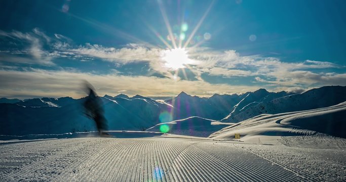 Motion control time-lapse of corduroy snow in the foreground and mountains view in the background.