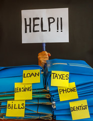 a person buried  under a pile of bill to pay asks  for help with