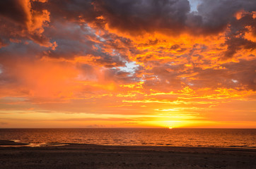 Fototapeta na wymiar Dramatic sunset at the beach