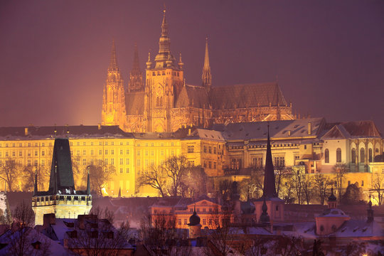 Night romantic snowy Prague gothic Castle above River Vltava, Czech republic