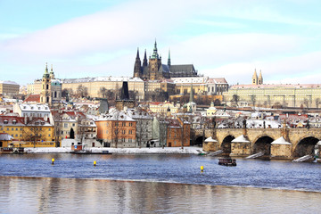 Christmas snowy Prague Lesser Town with gothic Castle and Charles Bridge, Czech Republic