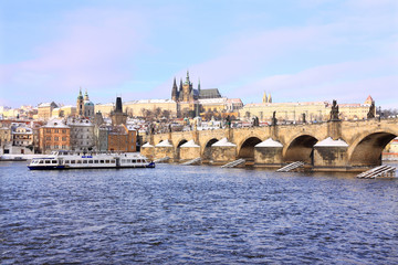 Obraz premium Christmas snowy Prague Lesser Town with gothic Castle and Charles Bridge, Czech Republic