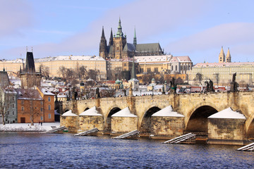 Christmas snowy Prague Lesser Town with gothic Castle and Charles Bridge, Czech Republic