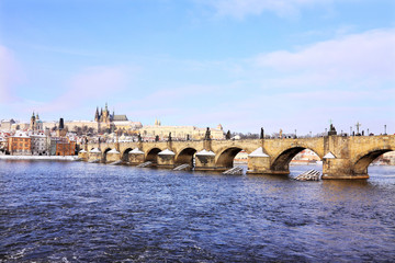Fototapeta premium Christmas snowy Prague Lesser Town with gothic Castle and Charles Bridge, Czech Republic