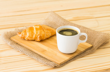 Coffee cup and croissant