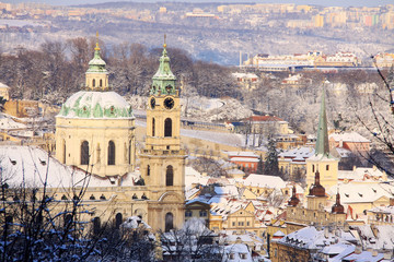 Obraz premium Christmas snowy Prague Lesser Town with St. Nicholas' Cathedral, Czech Republic