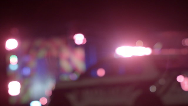 Ambulance, Cops and Firetrucks Blurry Lights Background at Night during a House Fire