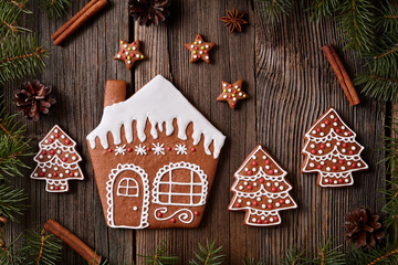 Gingerbread cookies house stars and fur trees in new year composition frame. Homemade traditional christmas dessert recipe