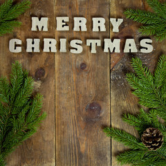 text Merry Christmas on old wooden background