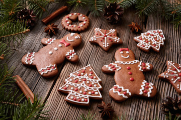Gingerbread cookies man and woman couple christmas composition with icing on vintage wooden table background. Traditional homemade recipe