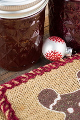 Two glass jars of jam and Christmas burlap bags.