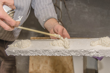 Applying PU foam on styrofoam.Thermal insulation.Selective focus