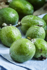 Ripe green feijoa on a blue linen napkin, selective focus