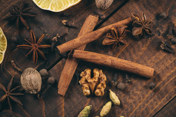 Collection of spices for mulled wine and pastry on the wooden table
