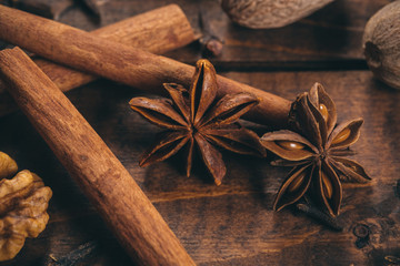 Collection of spices for mulled wine and pastry on the wooden table