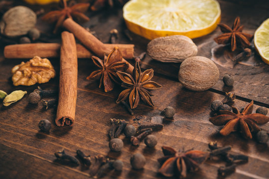 Collection of spices for mulled wine and pastry on the wooden table