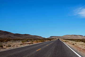 Straight highway through a desert area