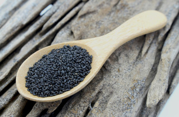 Basil seeds on wooden spoon
