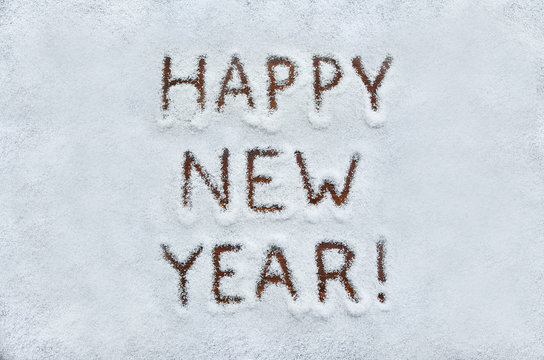 Text HAPPY NEW YEAR written on snow. Horizontal postcard.