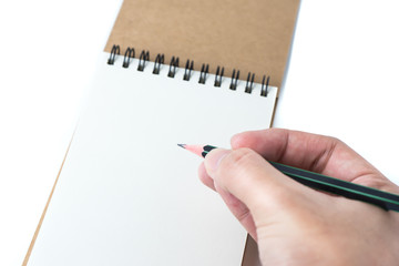 white sketch book and pencil with man hand on white