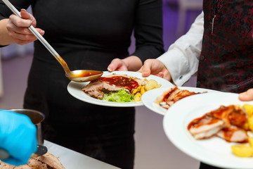 Restaurant workers prepare meals