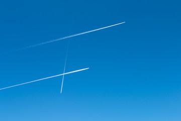 Jet Trails Pattern On Blue Sky