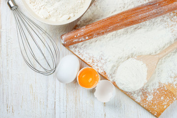 Baking ingredients on white wooden background