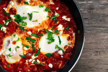 Fresh Eggs poached in Pan. In tomato sauce and onion, red, yellow pepper