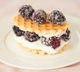 Golden waffles with blackberries and soft cheese