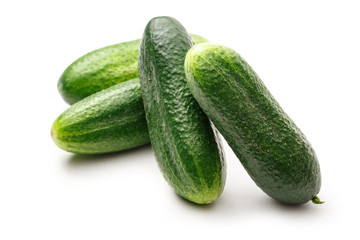 Fresh green cucumbers on white