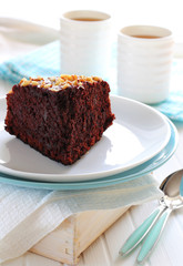 piece of chocolate cake with walnuts on two plates