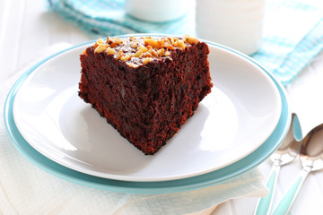 piece of chocolate cake with walnuts on two plates
