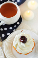 cupcake with whipped cream and cherry