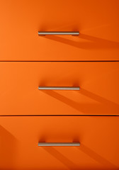 Orange wooden kitchen drawers