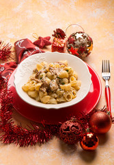 pasta with mushroom over red christmas table