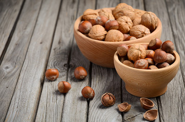 Hazelnuts and walnuts in a wooden bowl 