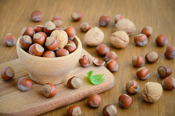 Hazelnuts and walnuts in a wooden bowl 
