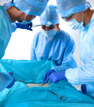 Team Of Surgeon In Uniform Perform Operation On A Patient At Cardiac Surgery Clinic