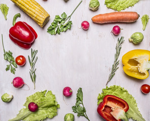 Delicious assortment of farm fresh vegetables lined frame on wooden rustic background top view close up place for text